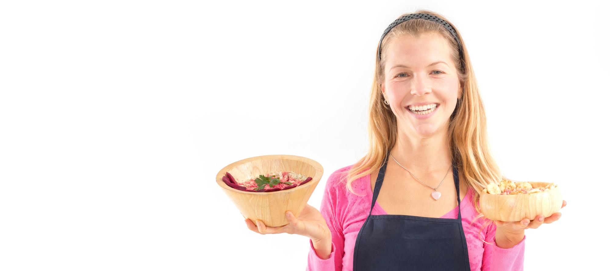 Student holding a plate in a bright home kitchen